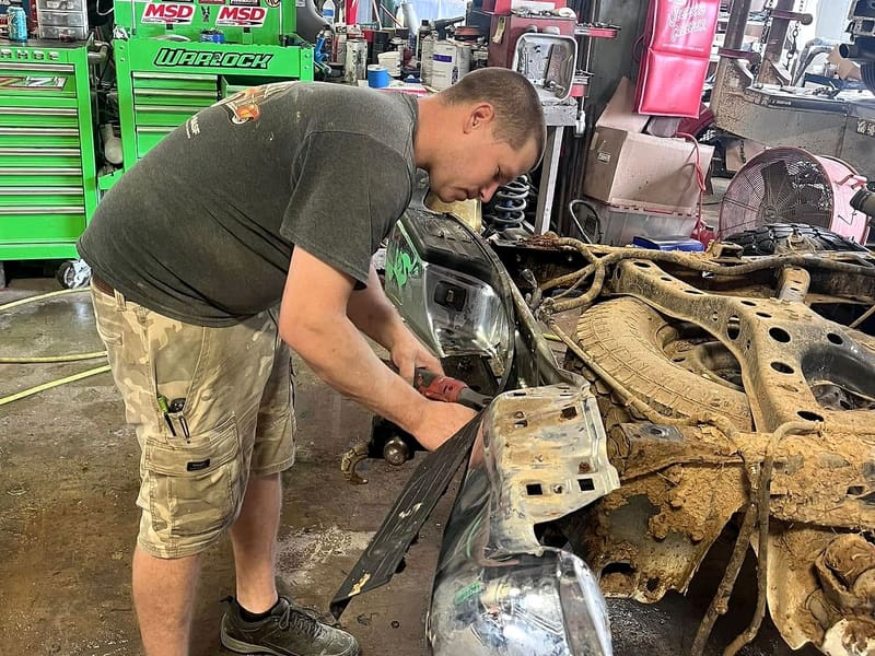 An Eastside tech working on a wrecked front end